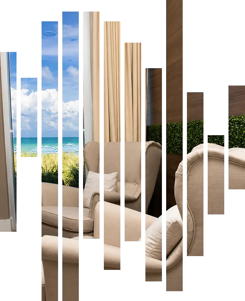 Relaxation lounge facing the ocean at HEED Spa Hallandale Beach, seen through twelve slats shaped like the HEED symbol